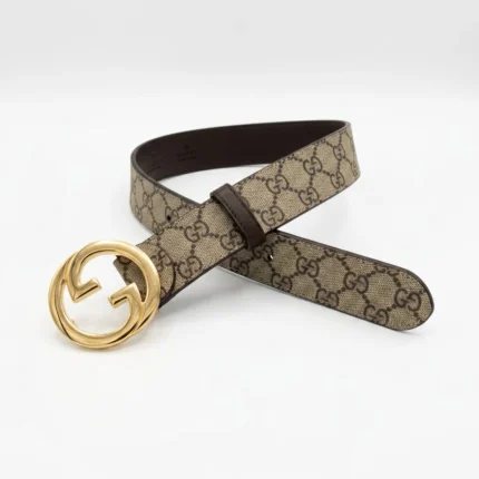 Gucci Blondie slim belt in GG Supreme canvas with gold toned interlocking G buckle for women.