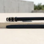 Slim black leather womens belt with a polished silver tone interlocking buckle (5)