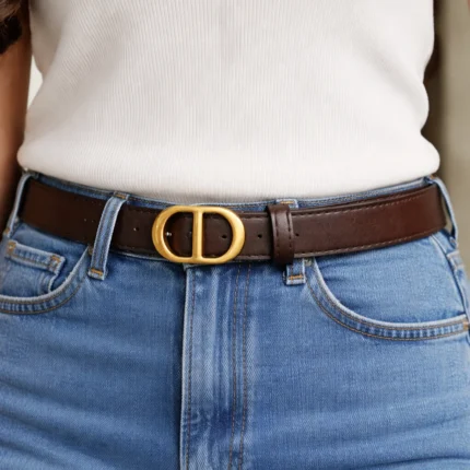 Slim dark brown leather belt for women featuring a matte gold oval CD buckle (2)