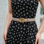 Slim womens taupe leather belt featuring an antique gold interlocking buckle on a stone pedestal (4)