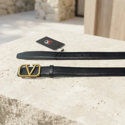 Women wearing a black leather belt with a gold V logo buckle (1)