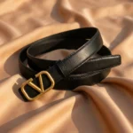 Women wearing a black leather belt with a gold V logo buckle (4)